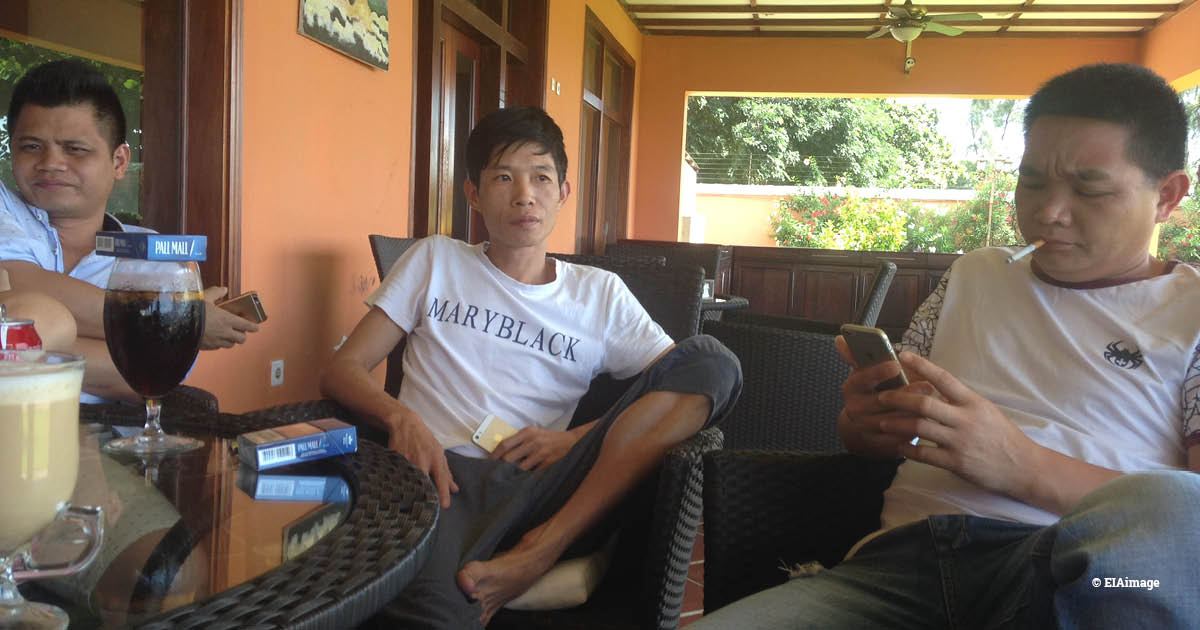 Three Chinese men meeting in a terrace in Mozambique