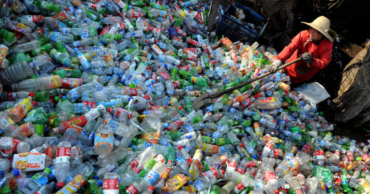 A woman sifts through a Pile of Plastic waste collected for processing