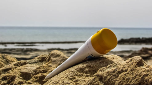 a suncream bottle on a beach